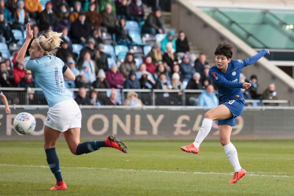 Ji So-yun shooting past Steph Houghton trying to block