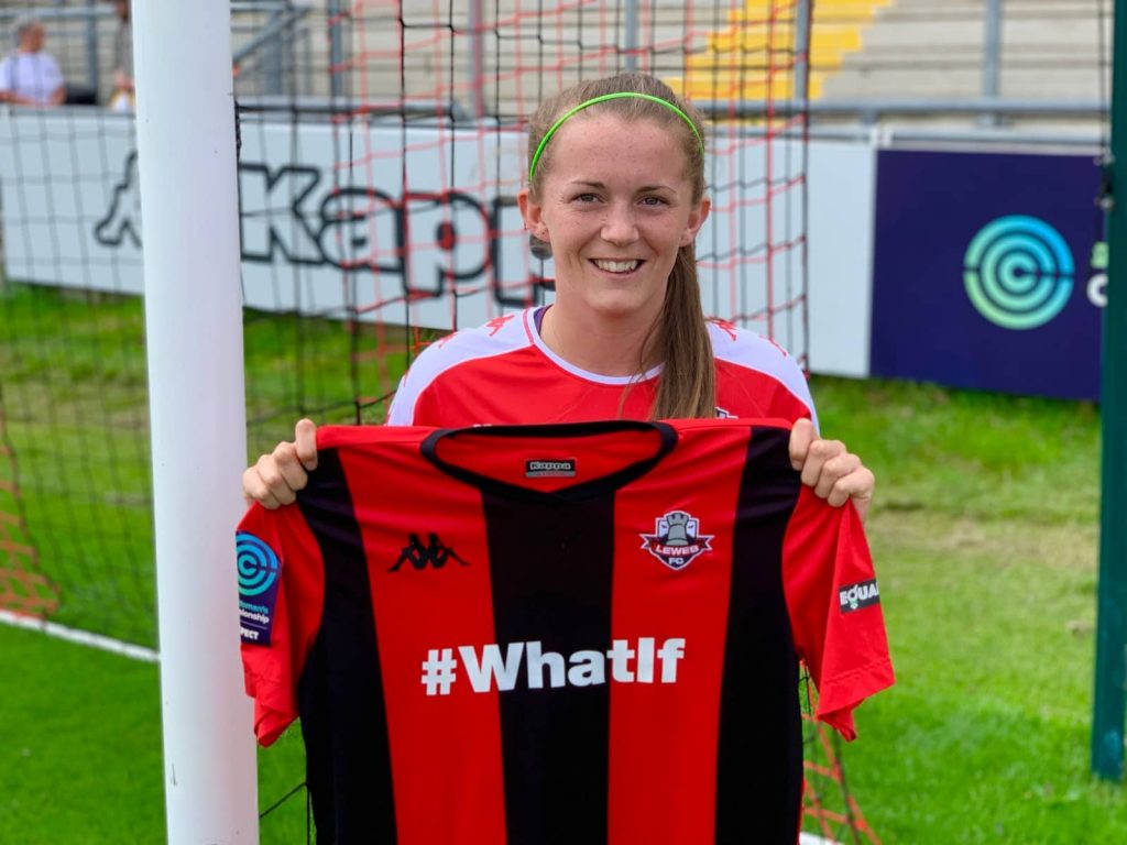 Molly Peters holding up Lewes FC shirt