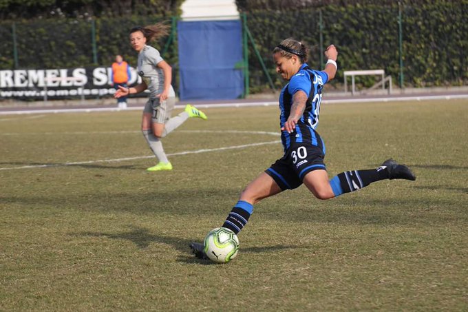 Adrienne Jordan clearing ball up field with left foot