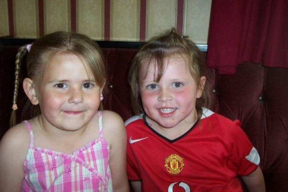 Chloe in Man United strip alongside Cousin Abby