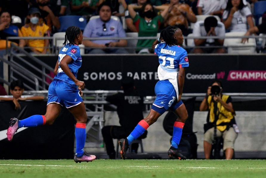 Haiti's Roselord Borgella (R) celebrates