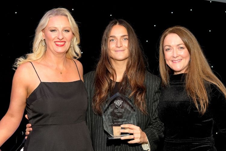 Elena Sadiku picking up her award from ScottishPower’s brand director Julie Keough and presenter Jane Dougall