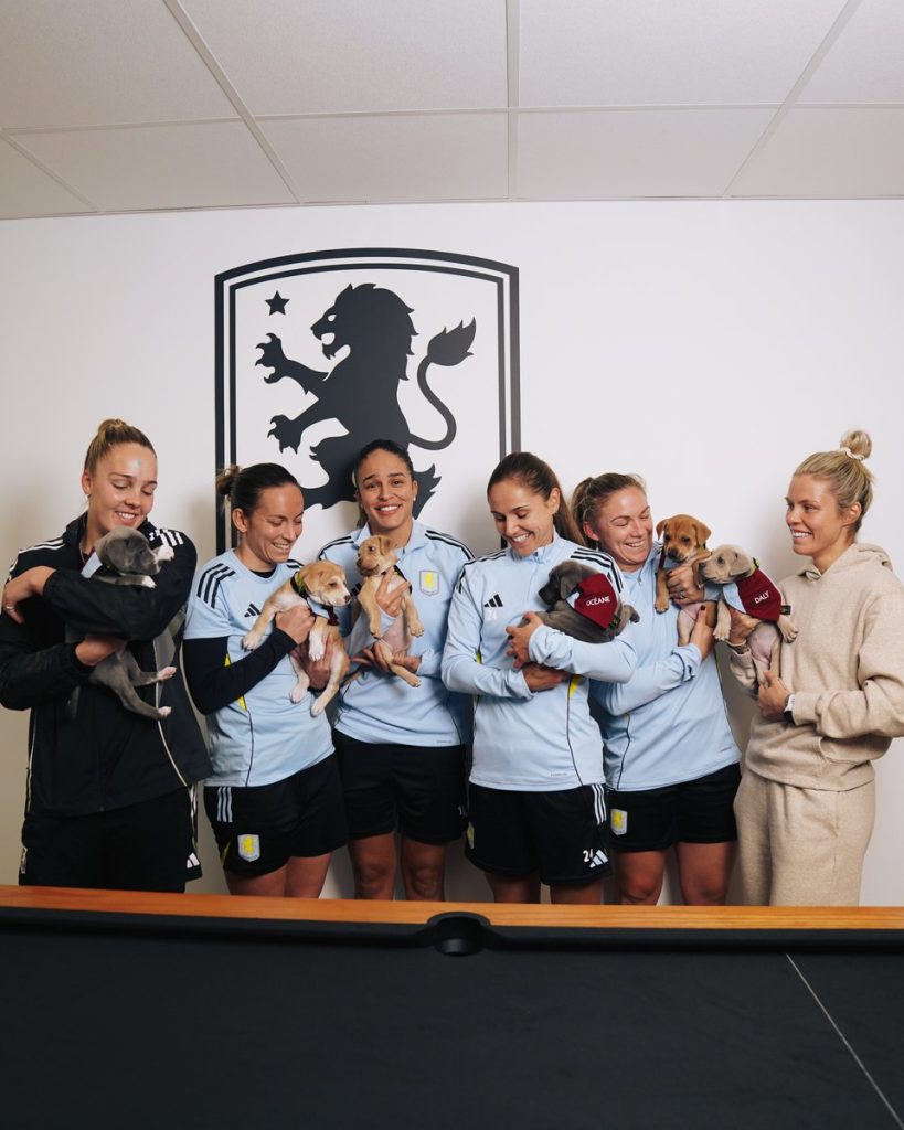 Villa players with the puppies