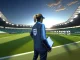 England women's football manager on touchline with squad training in background