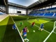 Seven-a-side football match in action at a modern stadium with players in dynamic movement