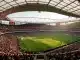 Emirates Stadium interior during Arsenal Women's match showing full pitch and crowd in red seats
