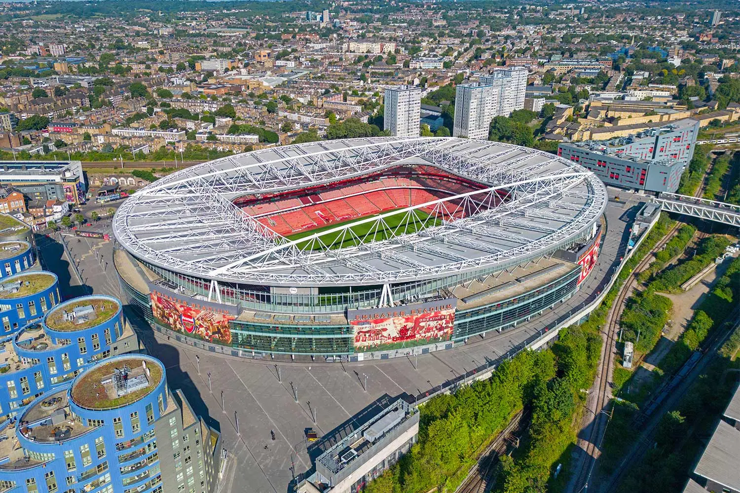Aerial view of Emirates Stadium in London with surrounding urban landscape.