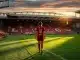 Liverpool FC Women player walking across Anfield pitch at sunset in emotional farewell moment