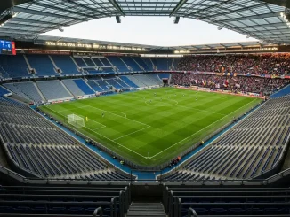 Modern football stadium interior showing contrast between filled and empty sections of seating