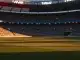 Floodlit stadium pitch at dusk with dramatic shadow patterns and packed stands, World Cup match venue.