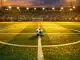 Floodlit stadium pitch with Australian flag colours, centre spot ball, dramatic evening shadows, aerial perspective.