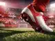 Floodlit football pitch with Austrian red and white lighting, close-up boot in motion, packed stadium stands in shadow.