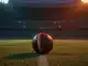 Floodlit football pitch at dusk with ball on penalty spot, blue and red-gold lighting, empty stands, low angle cinematic photography.