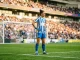 Brighton women's goalkeeper in blue and white kit standing in penalty area at stadium