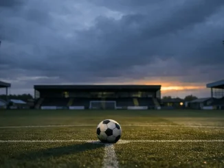 Empty football stadium at dusk with lone ball on pitch representing Durham Women FC uncertain future