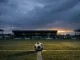 Empty football stadium at dusk with lone ball on pitch representing Durham Women FC uncertain future