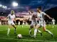 England Lionesses players training intensely on pitch under stadium lights ahead of World Cup qualifiers