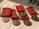 Six MBE medals on white silk representing Lionesses players' honours for Euro 2025 triumph