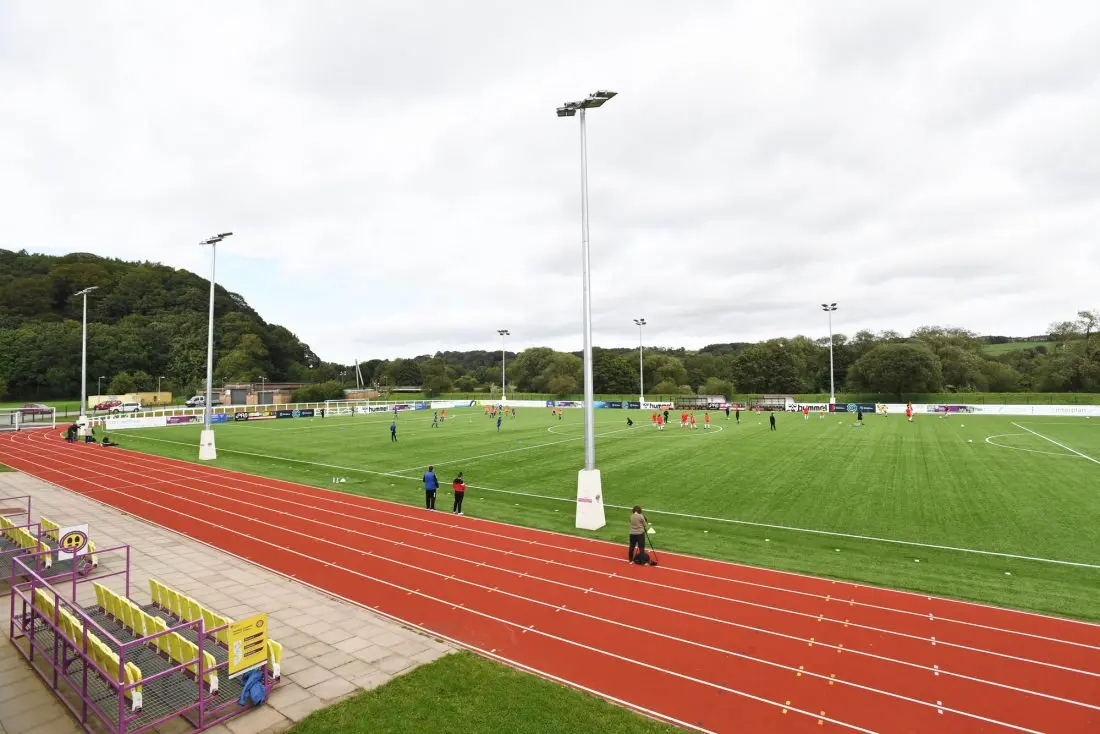 Maiden Castle Sports Park featuring a football field and spectators.