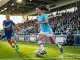 Female footballer in Manchester City kit driving forward on left wing during WSL match