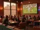 Modern Manhattan sports bar interior with viewing screen and intimate speakeasy atmosphere