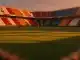 Empty floodlit stadium pitch at dusk with Tunisian and Dutch flag colours in stands, dramatic shadows, packed crowd.