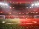 Floodlit stadium pitch at dusk in crimson and white, empty centre spot, dramatic shadows, packed stands in blur.