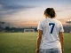England Lionesses player stands alone on pitch after defeat in contemplative moment under stadium lights