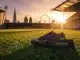 Football boot on stadium pitch with Barcelona armband and London skyline, symbolizing historic WSL transfer