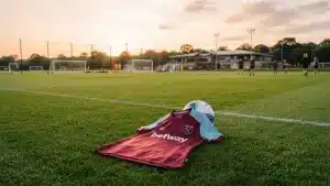 West Ham United women's jersey on training pitch symbolizing new signing