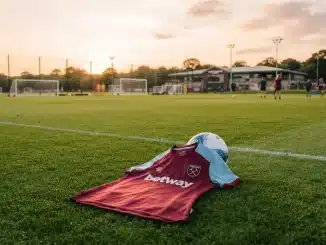 West Ham United women's jersey on training pitch symbolizing new signing