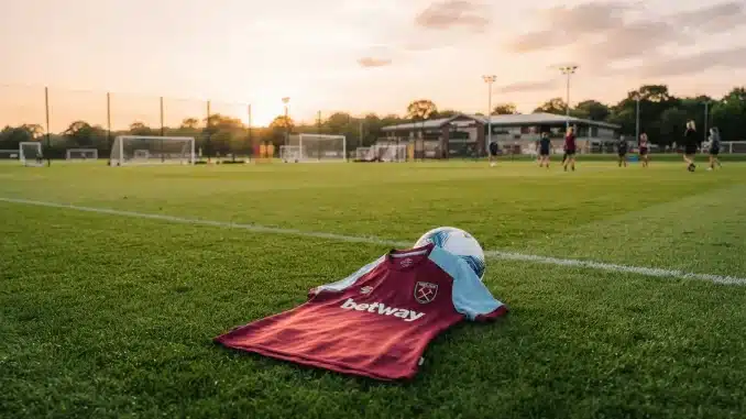 West Ham United women's jersey on training pitch symbolizing new signing