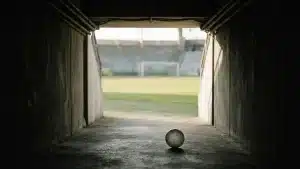 Empty stadium tunnel and football symbolise uncertainty around Poland's Under-20 Women's World Cup.