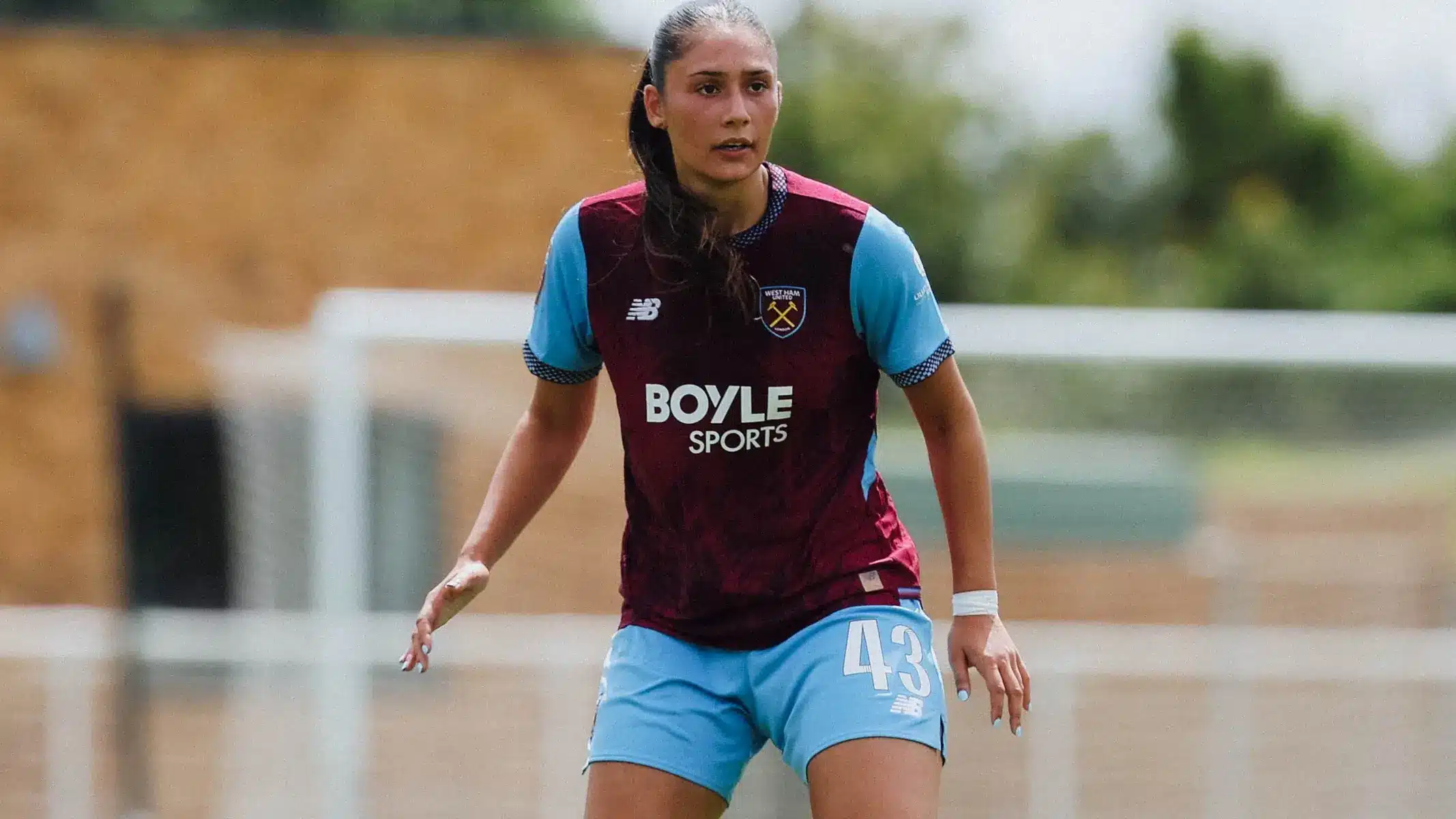 Selin Cemal in a West Ham United Women's claret and blue football kit on the pitch