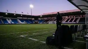Empty football technical area representing Dario Vidosic’s potential move from Brighton to Angel City