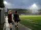 Two women footballers walk toward a floodlit Aberdeen pitch during a season-long loan move.